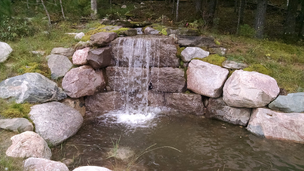TRAVERSE CITY, MICHIGAN. Construction of natural waterfall with outcroppings.